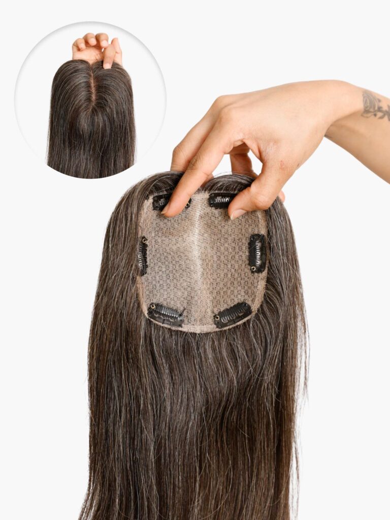 This Salt and Pepper Curly Silk Base Human Hair Topper is designed for women seeking natural coverage, realistic scalp appearance, and effortless blending with gray or transitioning hair. Crafted with a premium silk base, the topper creates a true-to-life scalp illusion by concealing visible knots, making the parting look clean and natural from every angle. Made from 100% ethically sourced human hair, this topper delivers soft movement, resilient curls, and long-lasting wear. The salt-and-pepper color blend is carefully balanced to match mixed gray tones, eliminating harsh contrasts and ensuring seamless integration with natural hair. Each unit is handmade for consistent density and curl definition, while the breathable base provides comfort for all-day wear, even in warm climates. The topper features secure pressure-sensitive clips that attach firmly without pulling or damaging natural hair. It is ideal for covering thinning areas at the crown or part line and can be styled with heat tools (within recommended temperatures), washed, and maintained like your own hair. Suitable for daily wear, professional settings, and special occasions, this topper offers confidence with a lightweight, undetectable finish. Key Benefits Realistic silk base for natural scalp look Salt and pepper curly texture for mature, blended tones Breathable, lightweight construction Secure clips for stable, damage-free attachment Heat-friendly human hair for versatile styling Technical Specification Table Specification Details Product Type Human Hair Topper Base Type Silk Base (Scalp Illusion) Hair Material 100% Human Hair Hair Color Salt and Pepper (Gray Blend) Texture Curly Base Size Options Customizable (Standard sizes available) Density Natural to Medium (Custom options available) Attachment Pressure-Sensitive Clips Cap Construction Handmade, Breathable Heat Styling Yes (Recommended ≤180°C) Hair Length Multiple lengths available Weight Lightweight (Varies by size & length) Suitable For Crown thinning, part coverage Maintenance Washable, reusable